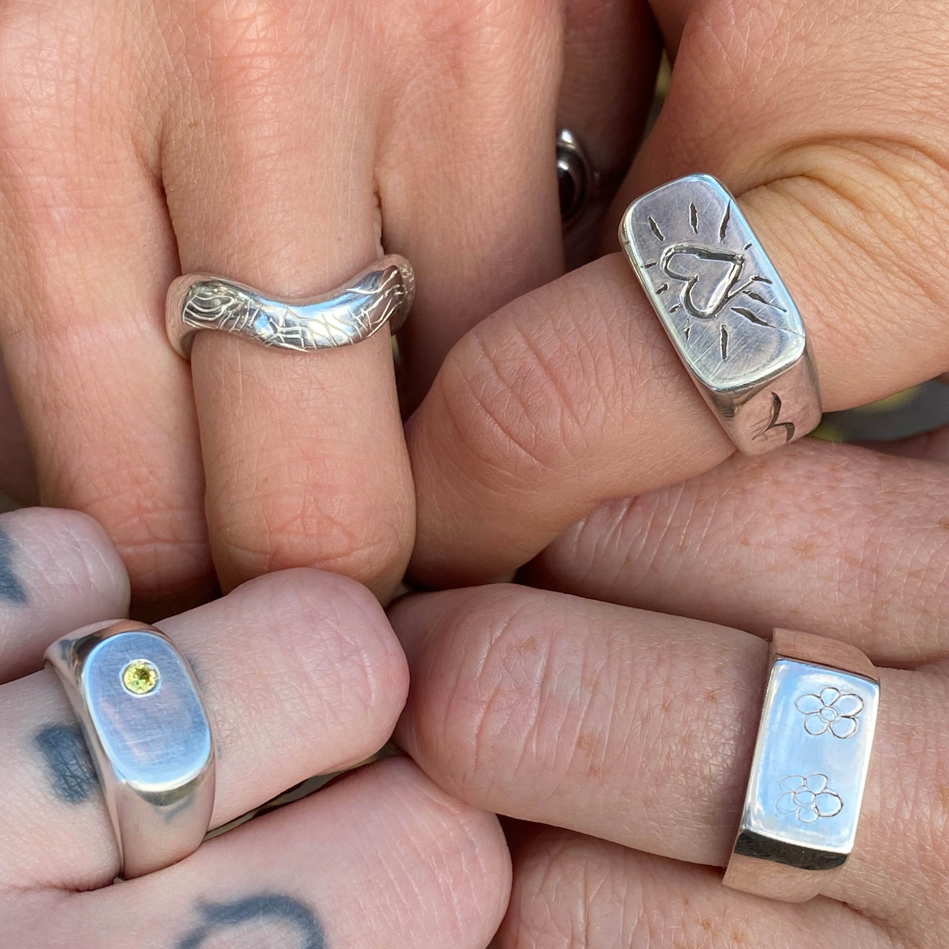four different rings which were made in the class on four different hands. 
