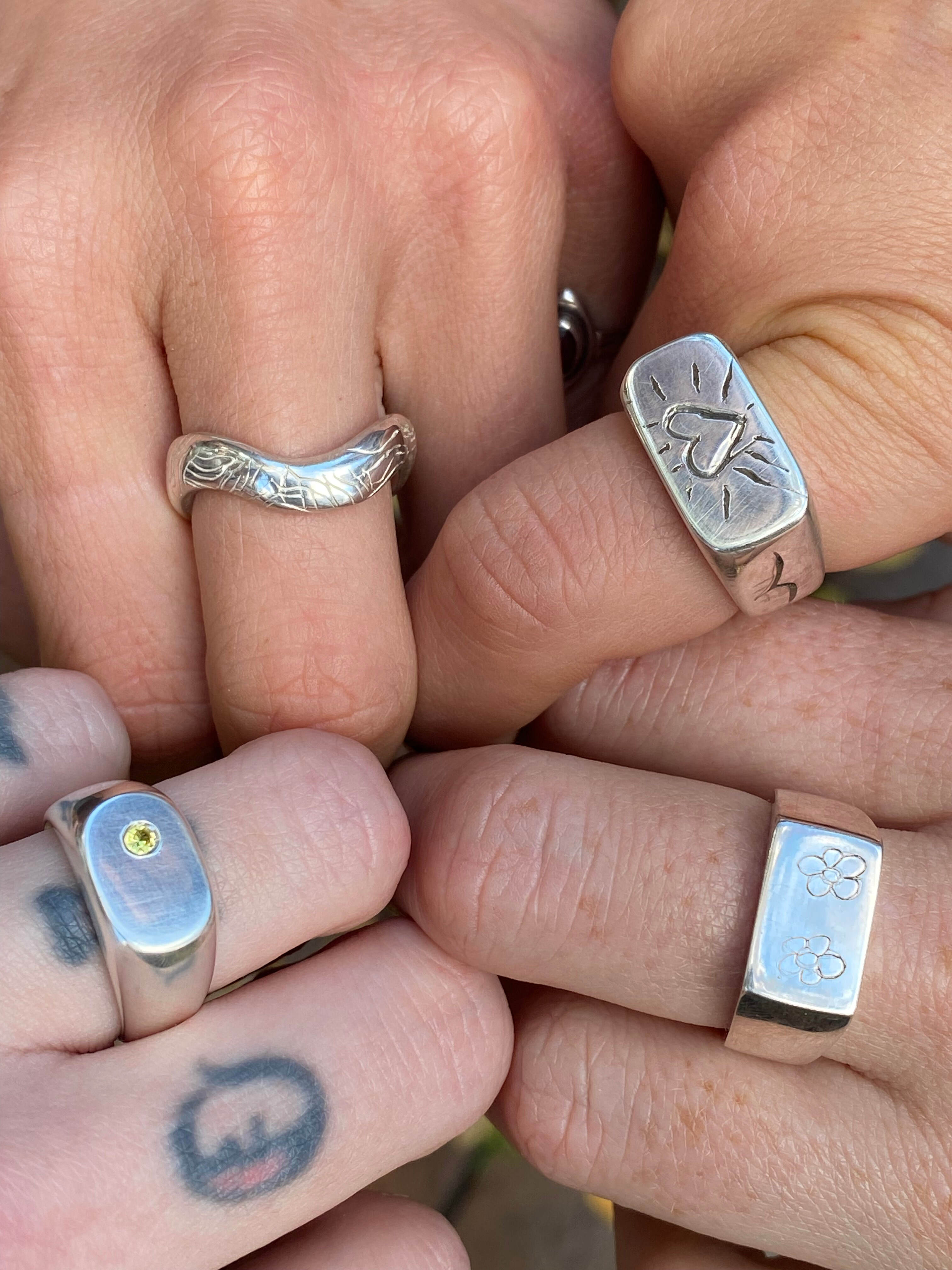 four different rings which were made in the class on four different hands. 