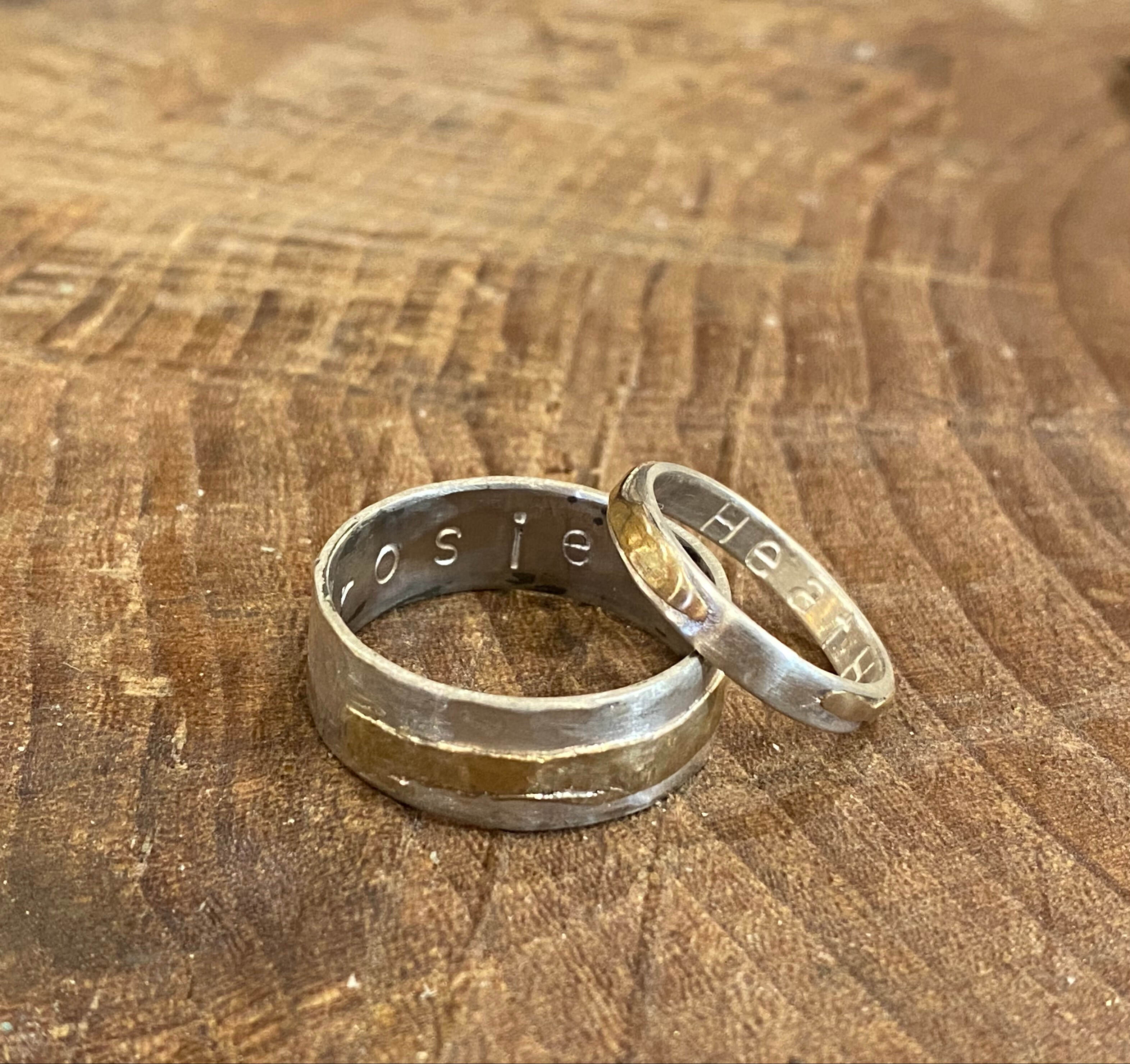 wedding rings made in ring making class on fingers of two different people